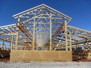 Wood framework of a post-frame construction barn.