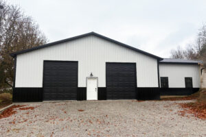 Residential post frame construction, dual garage, brown doors, white trim